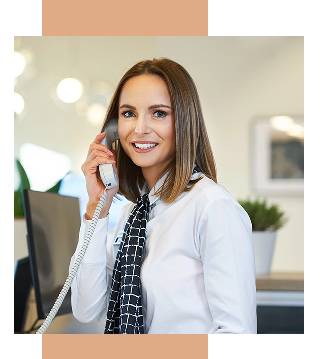 Receptionist at Celina Endodontics talking to a client on the phone in Dallas.